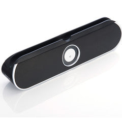 Portable Bluetooth and 3.5mm input speaker with kickstand and slot to hold phone or tablet.